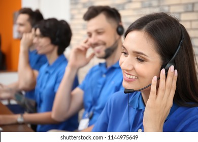 Technical support operators with headsets at workplace
