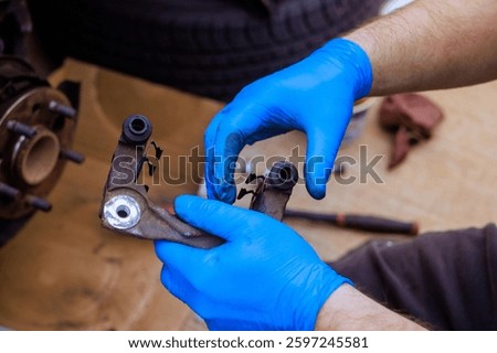 Technical worker assembles, maintains vehicle mechanical component in service garage.