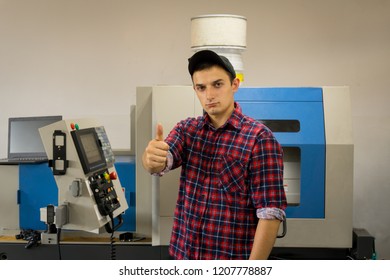 a technical worker is near the machine-tool of cnc