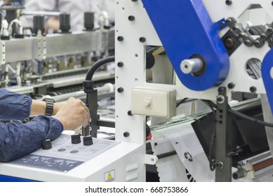 The Technician Adjust The Printing Machine.The Plastic Bag Manufacturing Process.