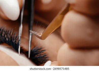 Technician is applying eyelash extensions with precision tools, emphasizing the detailed beauty process and the artistry involved in enhancing natural lashes