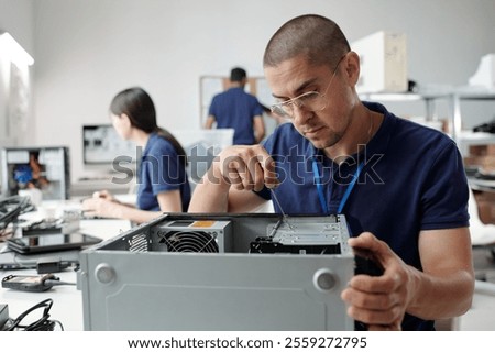 Technician Assembling Computer Hardware in Technology Lab
