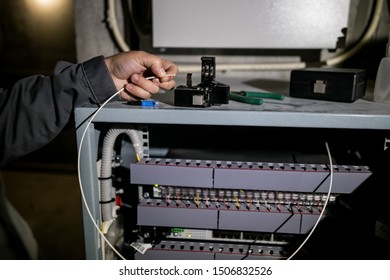 The technician attaching fiber optic on the Optical Distribution Frame. Man working in network server room with fiber optic hub for digital communications and internet.  - Shutterstock ID 1506832526