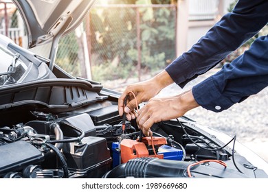 Technician auto mechanic using a power meter to check the car batter electric or electrical and engine system for service repairing maintenance and during the old car is periodic inspection.
