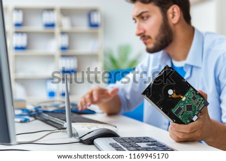 Technician with broken hard drive