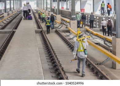 Technician Carry Measuring Gauge For Measure Track Gauge Or Distance Between Running With Conductor Rail For Make Sure Distance Comply With Criteria On Viaduct Of Sky Train.