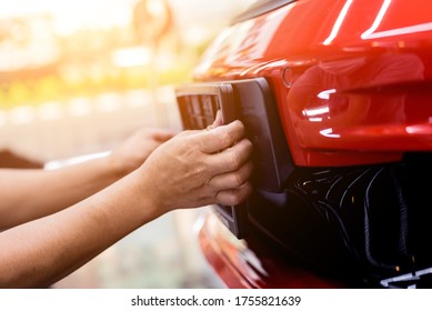 Technician Changing Car Plate Number In Service Center.