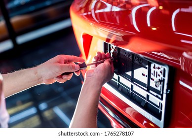 Technician Changing Car Plate Number In Service Center.