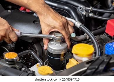 Technician Changing Engine Oil Filter. Car Maintenance Concept.