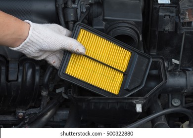 Technician is changing new air filter for car