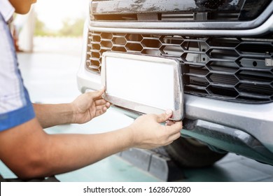 Technician changing Thailand car plate number in service center - Shutterstock ID 1628670280