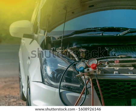 technician checking air conditioner in engine room of  car , cleaning air conditioner of car 