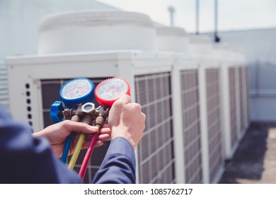 Technician is checking air conditioner ,measuring equipment for filling air conditioners.