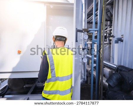 A technician is checking the commissioning of the machine before the machine is running.