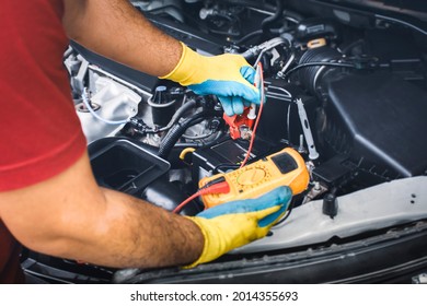 Technician Checking DC Voltage Stable Of The Car Battery With Digital Multimeter Probe