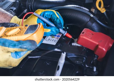 Technician Checking DC Voltage Stable Of The Car Battery With Digital Multimeter Probe