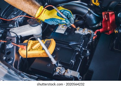 Technician Checking DC Voltage Stable Of The Car Battery With Digital Multimeter Probe