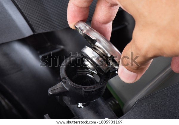 Technician checking the level of coolant fluid\
in the car. Car maintenance\
concept.