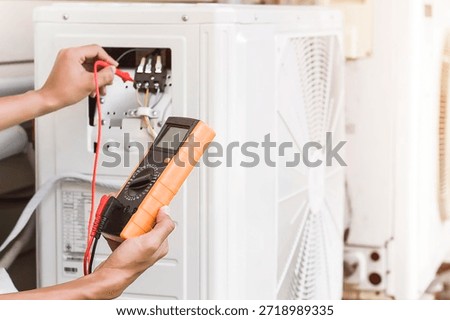 Technician checking the operation of the air conditioner