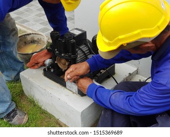 The Technician Is Checking The Water Pump.