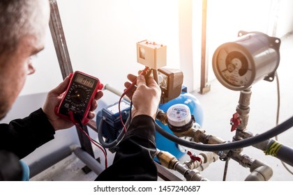 Technician Checking Water System Nodes. Industrial Background