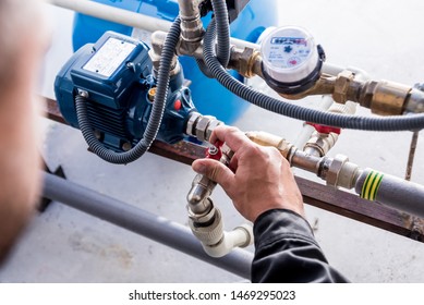 Technician Checking Water System Nodes. Industrial Background