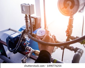 Technician Checking Water System Nodes. Industrial Background