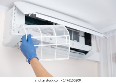 Technician Cleaning Air Conditioner. Hand Holding Air Conditioning Filter