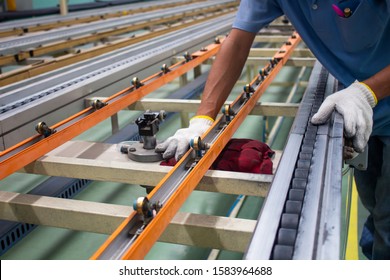 The Technician Cleaning Conveyor Belt In Production Line At Factory Plant