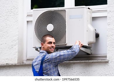 Technician Cleaning And Repairing Air Condition Appliance. AC Unit Maintenance