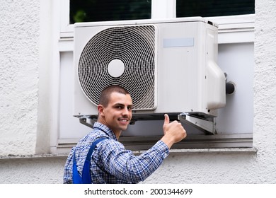 Technician Cleaning And Repairing Air Condition Appliance. AC Unit Maintenance