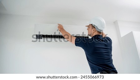 technician cleans air conditioner system in a modern apartment.