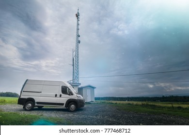 Technician Climbing On Top Of Telecom Tower For Maintenance In The Field.