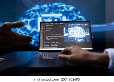Technician and colleague use AI cognitive computing to extract information from complex data on laptop. Close up of teamworking IT experts using artificial intelligence on notebook