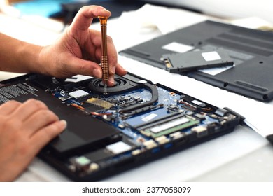 technician computer technician Laptop motherboard repairman using screwdriver to remove computer equipment To take it out and repair it so it can be used.