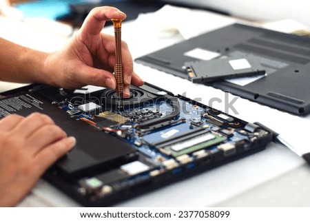 technician computer technician Laptop motherboard repairman using screwdriver to remove computer equipment To take it out and repair it so it can be used.