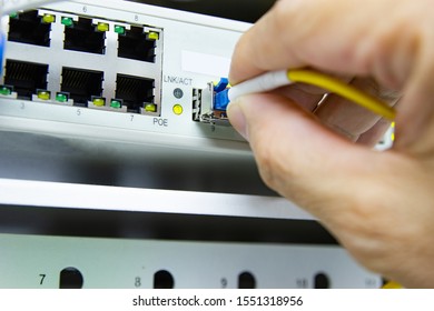 Technician connect fiber cable network to switch port in server room , Concept internet network management - Powered by Shutterstock