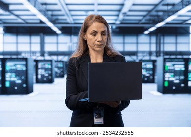 Technician in data center implementing backup solutions to protect against data loss using notebook, ensuring efficient recovery processes. Server hub worker identifying and resolving technical issues