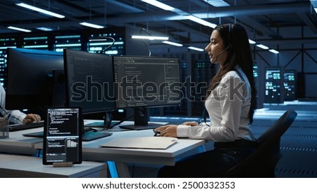 Technician in data center provides technical support to users, troubleshooting issues, close up. Server hub workers carrying out operational technical interventions requested by clients, camera B