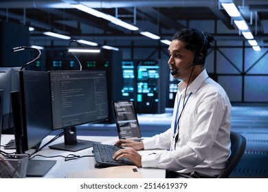 Technician in data center providing support for partnering startups, troubleshooting malfunctions. Worker in server hub call center carrying out operational interventions requested by clients