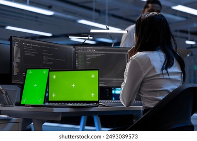 Technician in data center using isolated screen tablet and laptop to check for server issues arising due to high CPU usage. Server hub worker fixing insufficient memory errors with chroma key devices - Powered by Shutterstock