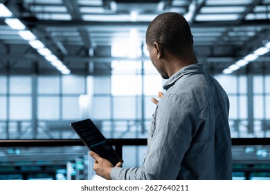 Technician in data center using tablet adjusting power management settings, verifying compliance requirements. Engineer in server room optimizes resource utilization, maintaining stable infrastructure