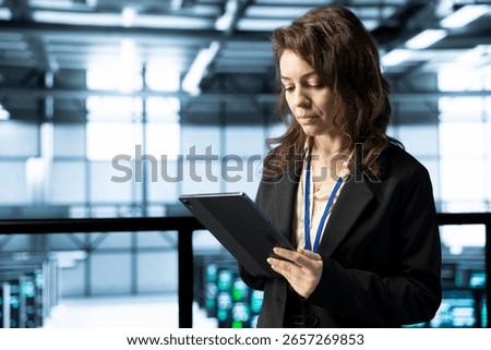 Technician in data center using tablet, integrating green technologies, implementing sustainable energy solutions, reducing resource consumption to maintain environmental standards