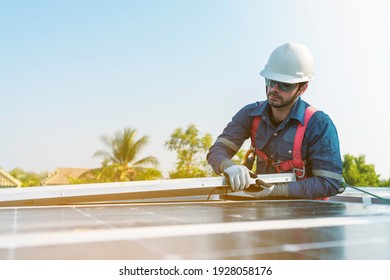 A Technician Doing Install The Solar Panels At Roof Top Of Home And Home Office ,concept Of Economic Energy And Cost Saving ,small Own Business Concept