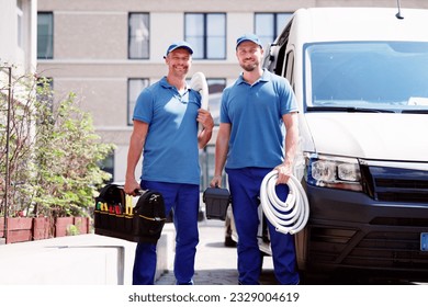 Technician Electrician Man With Cable Near Van