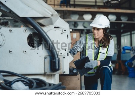 Technician Engineer Operating Robotic Arm in Factory, Automation and Advanced Technology to Enhance Production Control in Manufacturing Industry, Driving Innovation and Efficient Machine Work