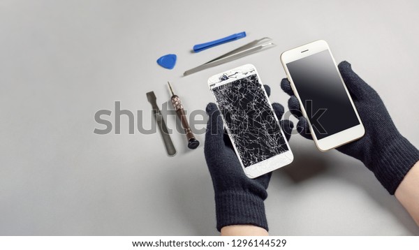 Technician or engineer preparing to repair and
replace new screen broken and cracked screen smartphone preparing
on desk with copy
space