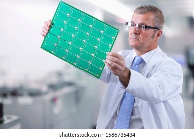 Technician Examining Circuit Board In Electronics Factory - Powered by Shutterstock