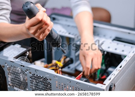 A technician expertly assembles a computer showcasing the intricacies of the technology DIY process.