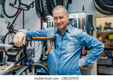 Technician fixing bicycle in repair shop. Stylish bicycle mechanic doing his professional work in workshop. Technical expertise taking care Bicycle Shop.  - Powered by Shutterstock